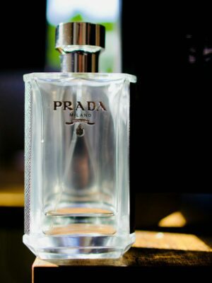 Prada cologne bottle on a wooden surface