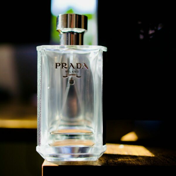 Prada cologne bottle on a wooden surface