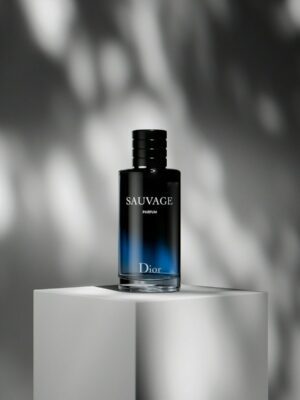 a bottle of cologne sitting on top of a white block