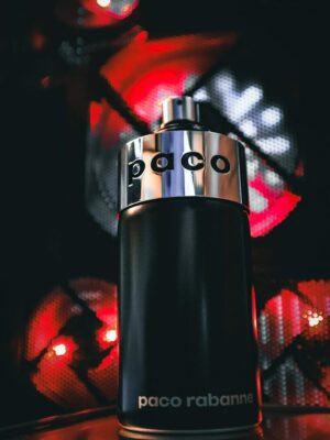 a close up of a bottle of perfume on a table
